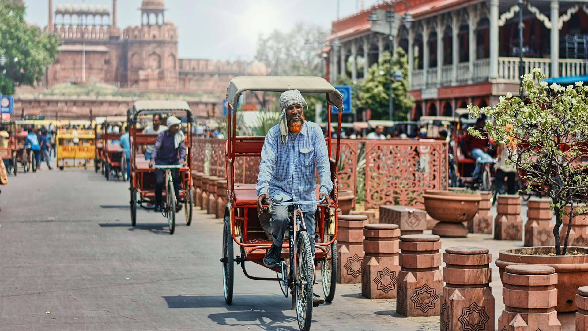 uomo che guida un risciò per le strade di Vecchia Delhi in India